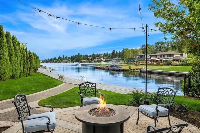 a view of a chairs and table in patio with a lake view