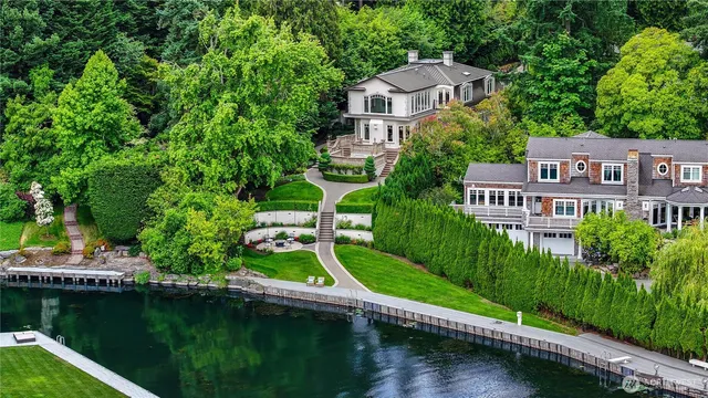 a view of a house with a yard and a pond
