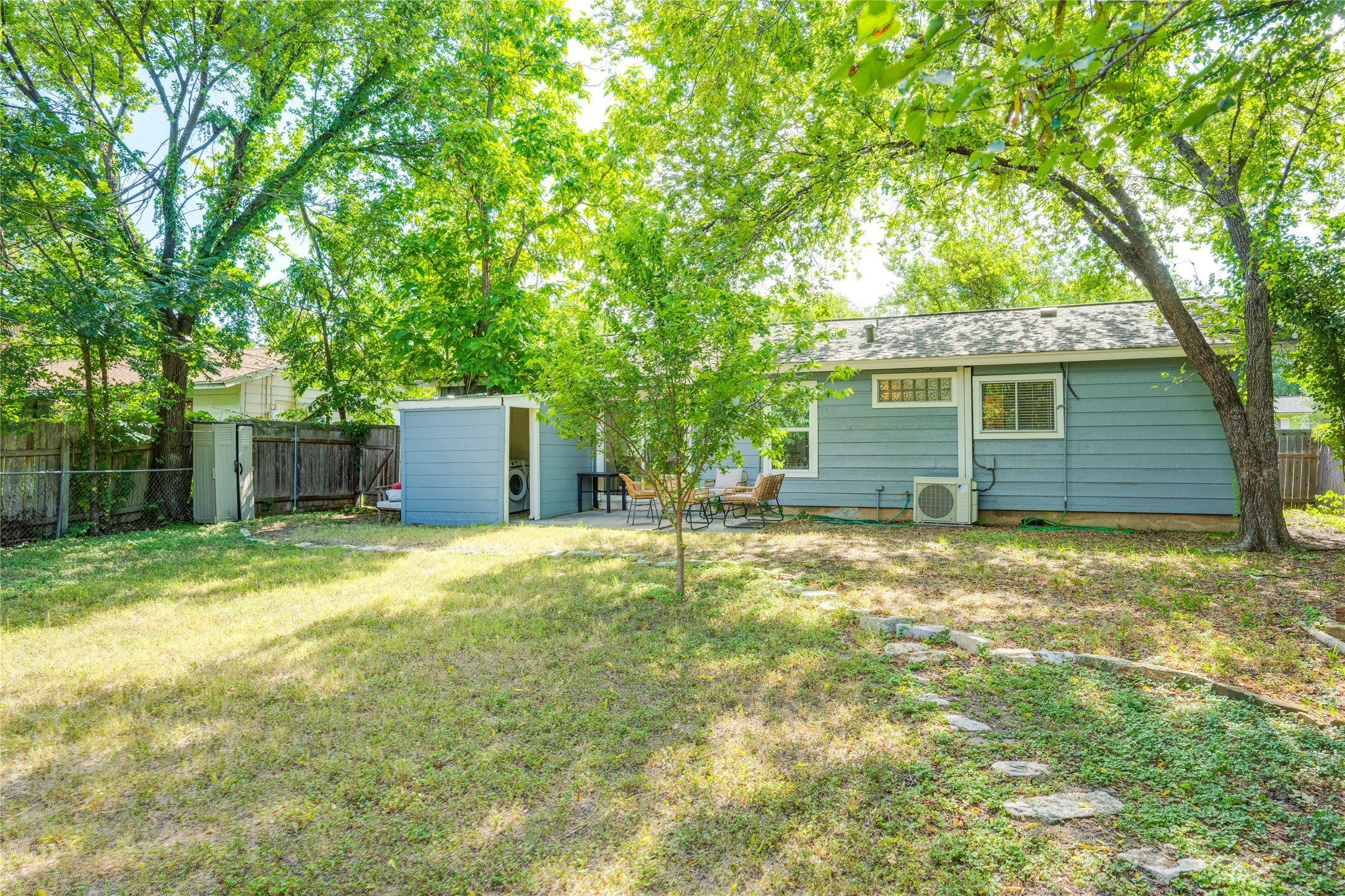 5300 Halmark Drive Austin, TX 78723 - Photo 29 of 40 A fenced backyard offers a patio for outdoor dining and a convenient storage shed.