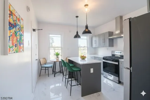 a kitchen with stainless steel appliances granite countertop a stove and a refrigerator