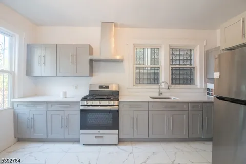 a kitchen with a stove sink and cabinets