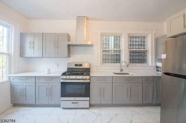a kitchen with a stove sink and cabinets