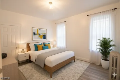 a bedroom with a bed and potted plant