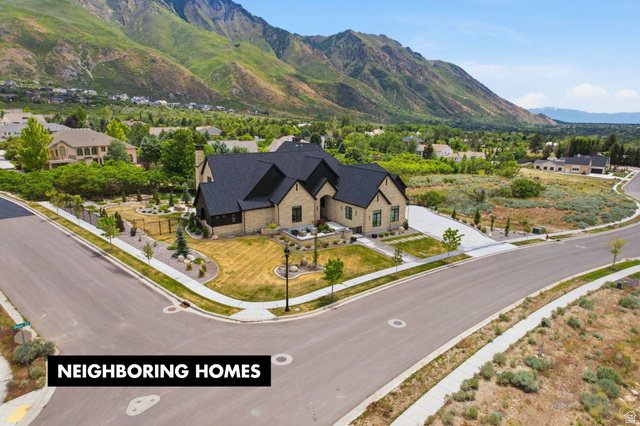 1817 North Dean Court, Unit 12 Alpine, UT 84004 - Photo 32 of 38 Stone exterior residence with a dark shingle roof, established landscaping, a concrete driveway, and a corner lot position