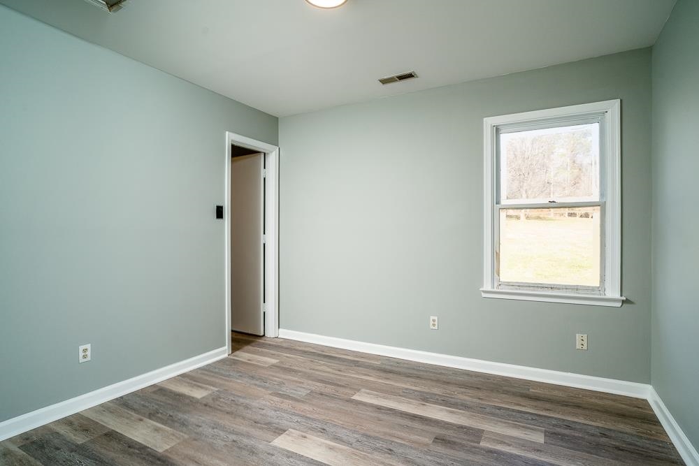 80 Phlox Road Ruckersville, VA 22968 - Photo 11 of 30 an empty room with wooden floor and windows