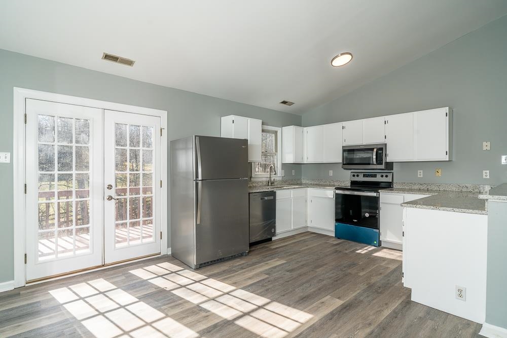 80 Phlox Road Ruckersville, VA 22968 - Photo 3 of 30 a kitchen with granite countertop a refrigerator stove top oven and sink