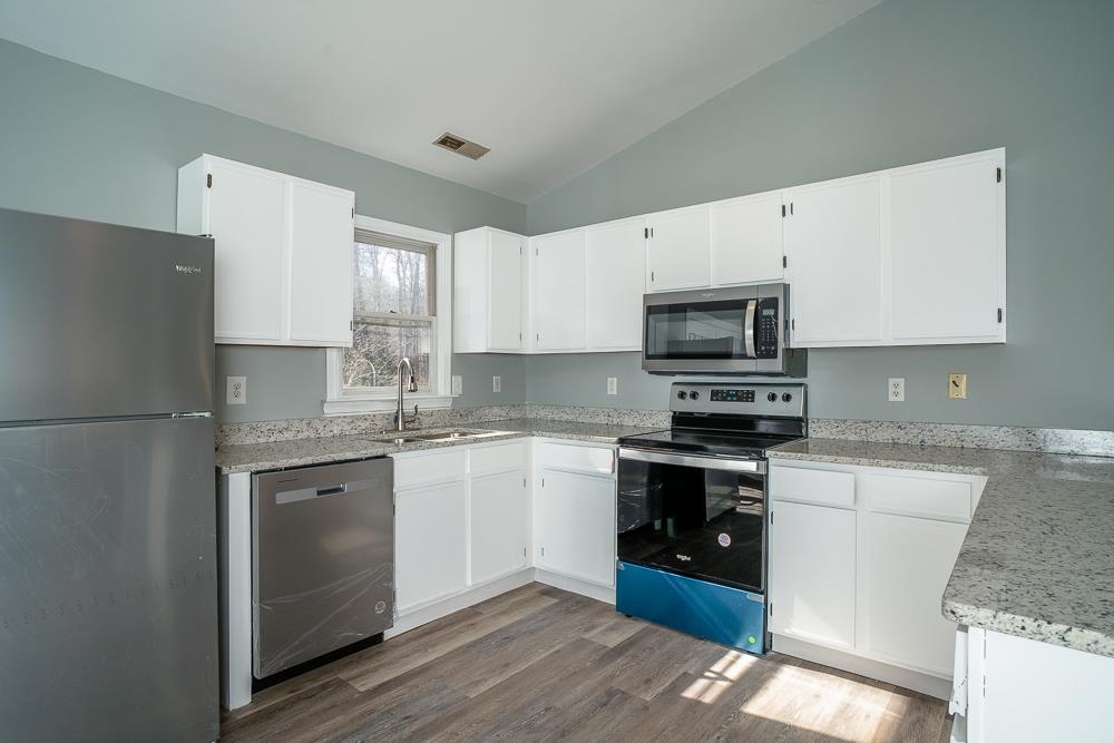80 Phlox Road Ruckersville, VA 22968 - Photo 4 of 30 a kitchen with stainless steel appliances granite countertop a stove top oven a sink and a refrigerator