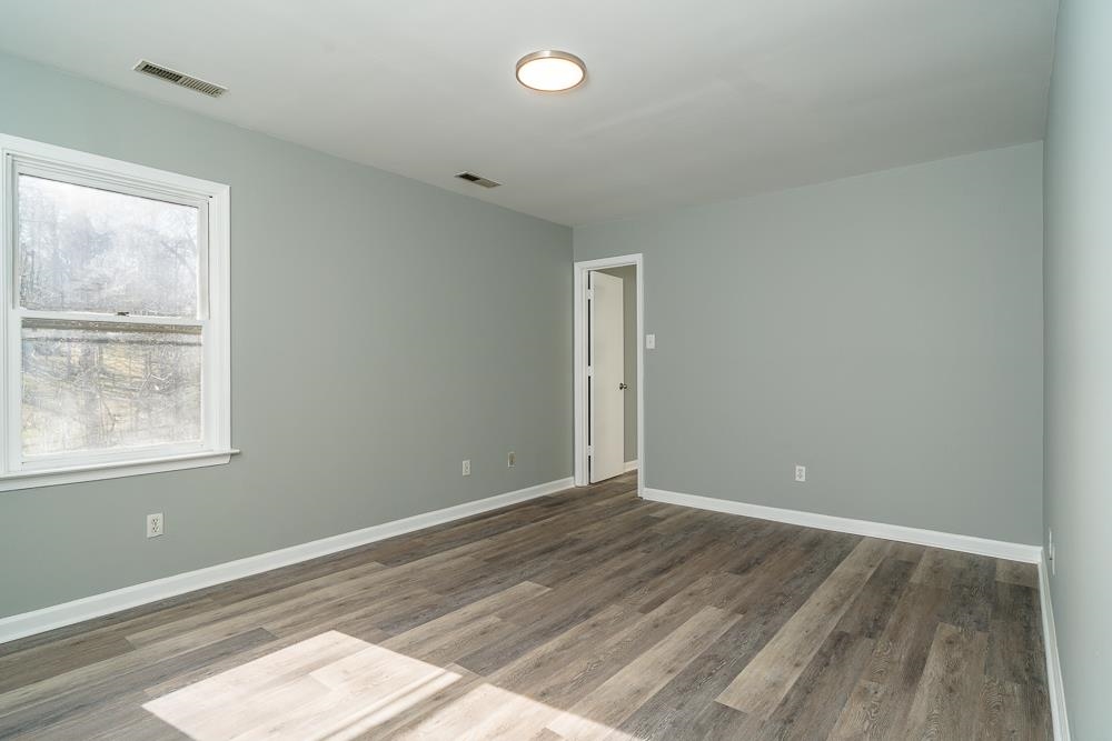 80 Phlox Road Ruckersville, VA 22968 - Photo 7 of 30 an empty room with wooden floor and windows