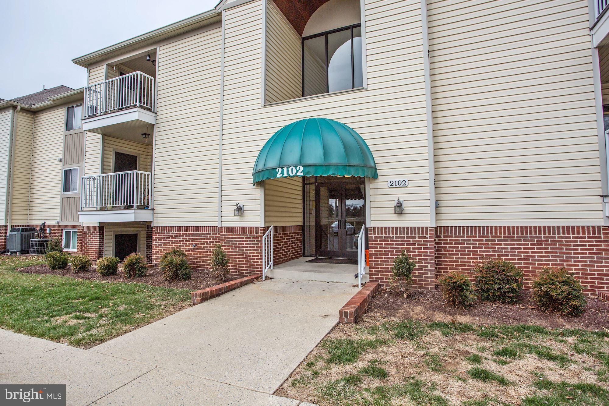 2102 Whitehall Road, Unit 2C Frederick, MD 21702 - Photo 2 of 28 a front view of a house with garden