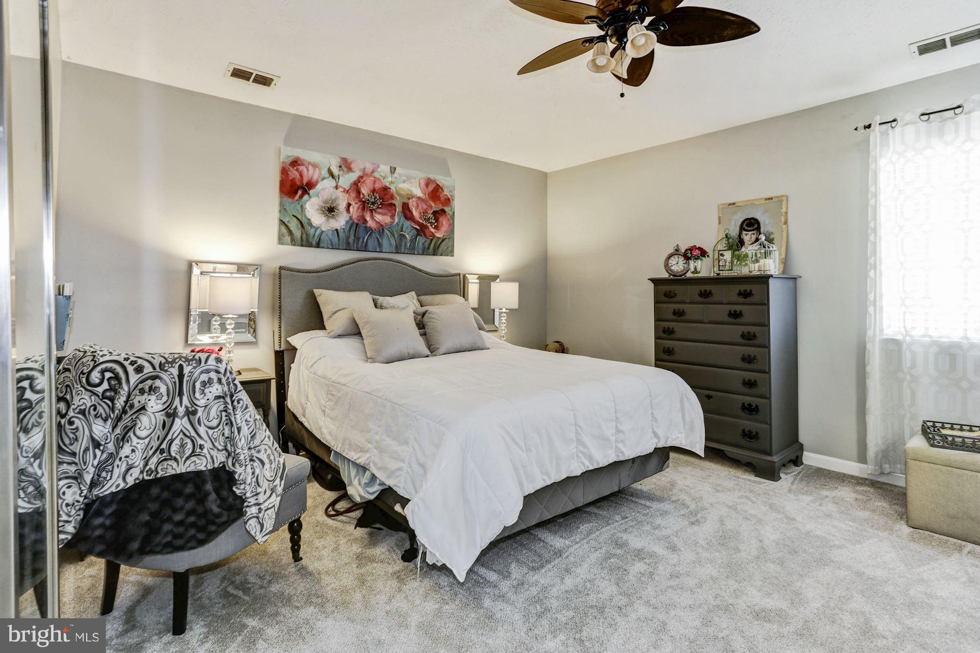 2102 Whitehall Road, Unit 2C Frederick, MD 21702 - Photo 13 of 28 a bedroom with a bed and a chandelier