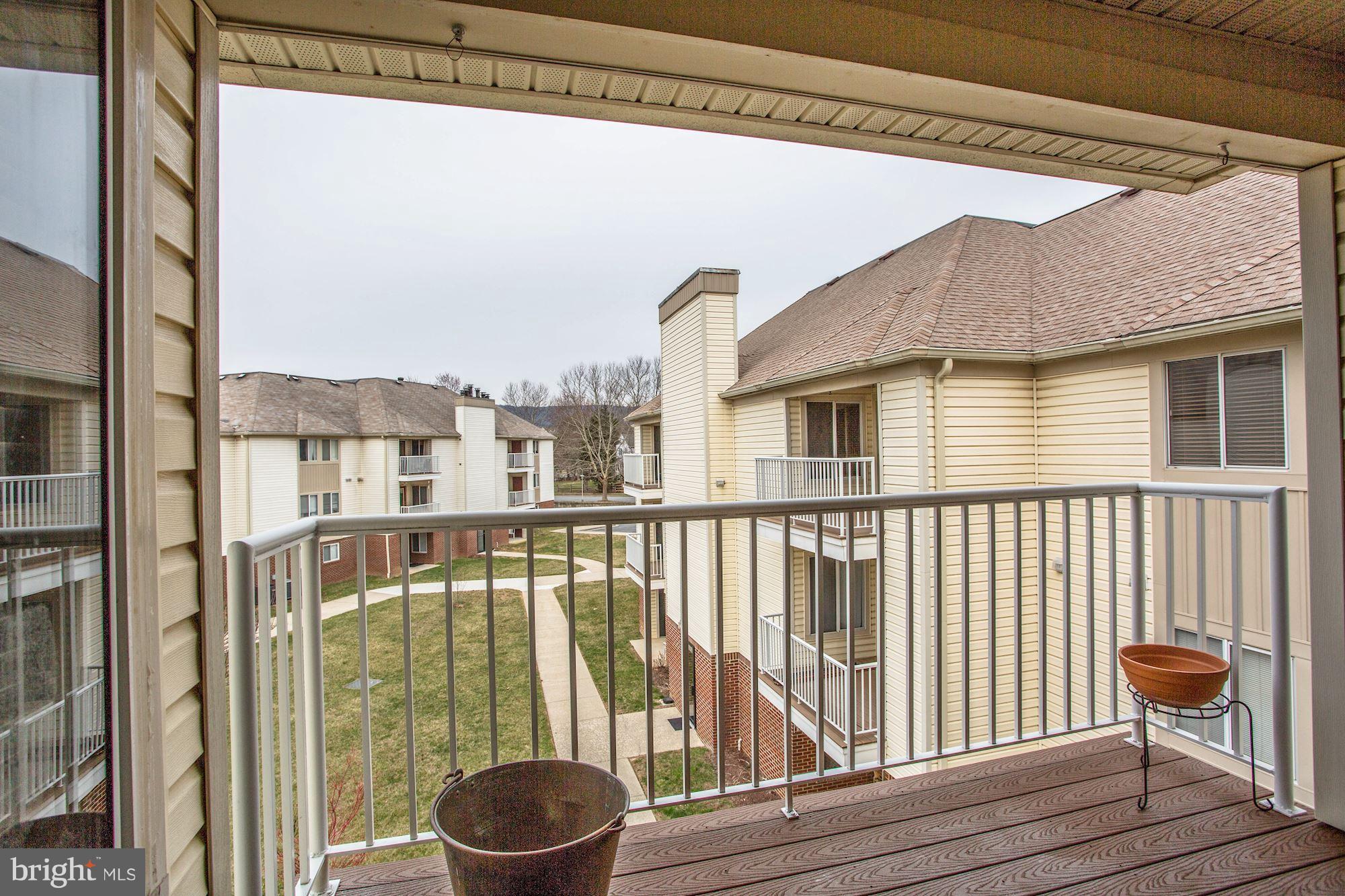 2102 Whitehall Road, Unit 2C Frederick, MD 21702 - Photo 22 of 28 a view of a balcony with chair and wooden floor