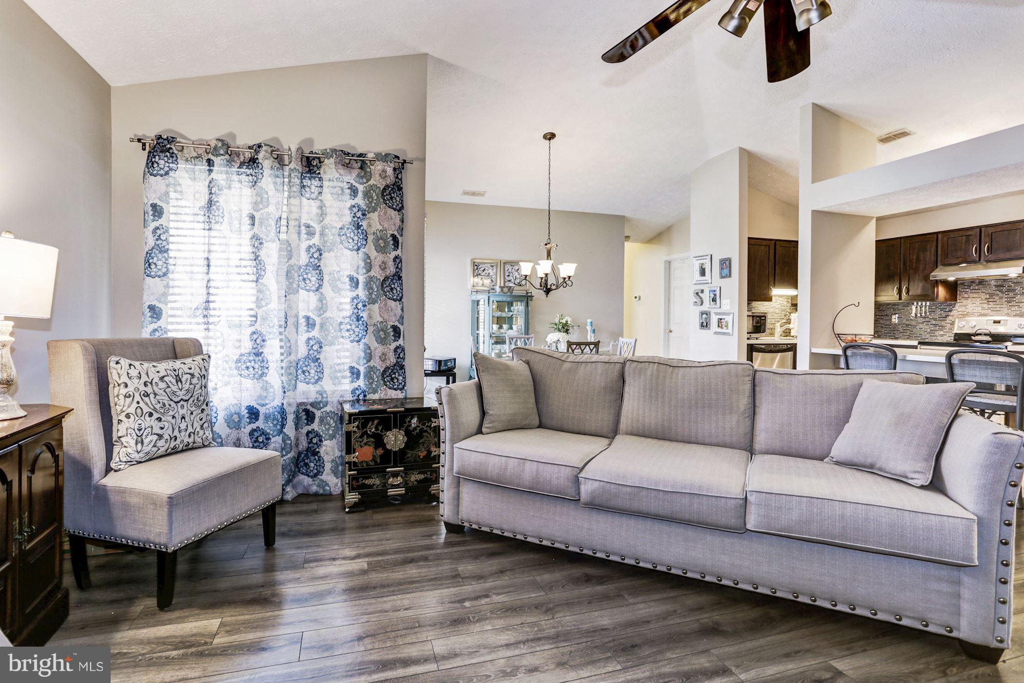 2102 Whitehall Road, Unit 2C Frederick, MD 21702 - Photo 5 of 28 a living room with furniture and a chandelier