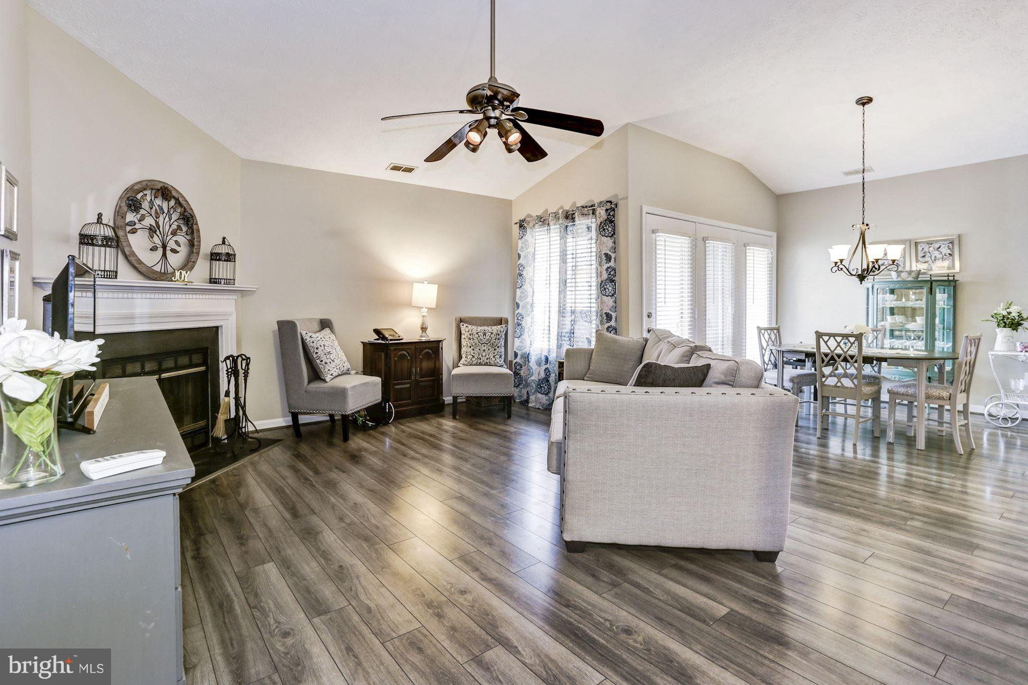 2102 Whitehall Road, Unit 2C Frederick, MD 21702 - Photo 27 of 28 a living room with furniture a fireplace and a chandelier