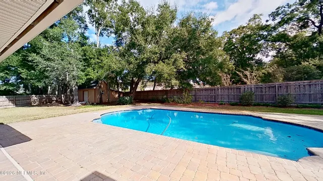 a view of a swimming pool with a yard