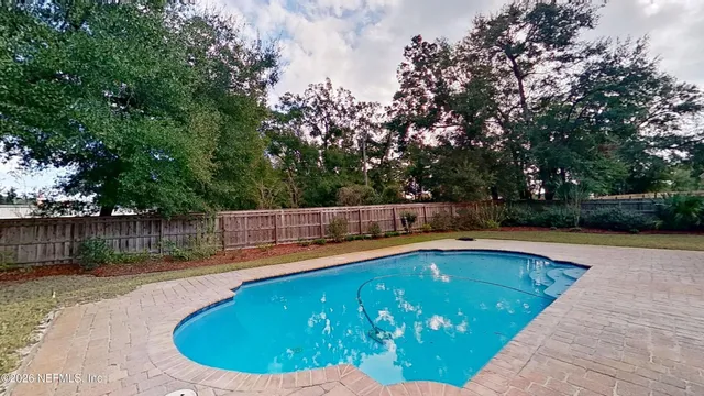 a view of a swimming pool with a patio