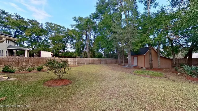a backyard of a house with table and chairs