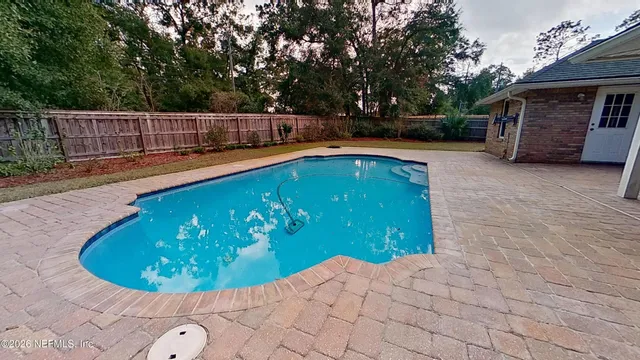 a view of a swimming pool with a patio