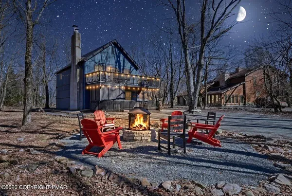 a backyard of a house with barbeque oven table and chairs