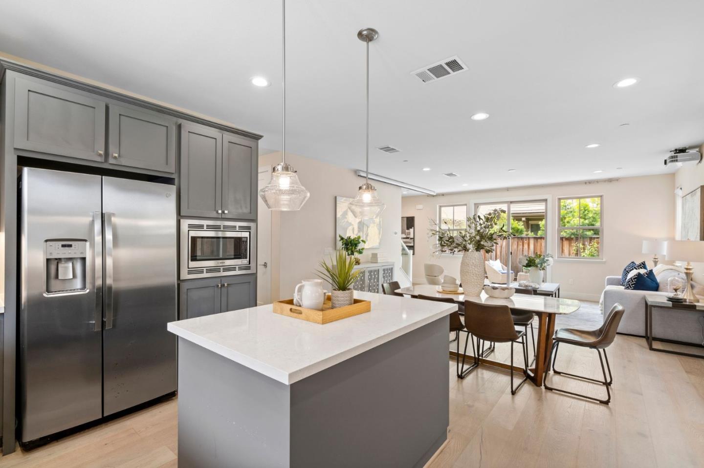192 Melia Loop Mountain View, CA 94043 - Photo 14 of 40 a kitchen with a table chairs refrigerator and cabinets