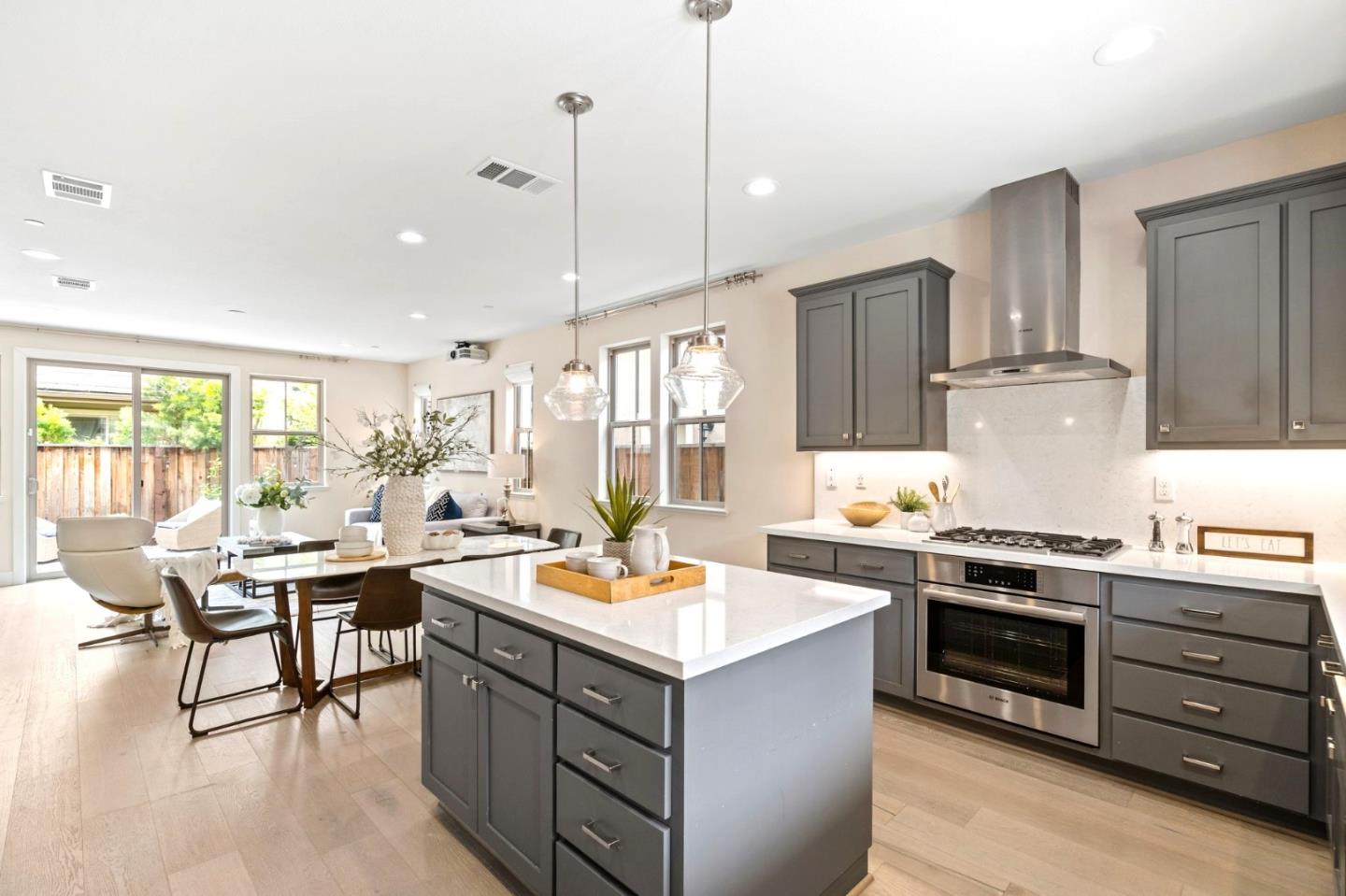192 Melia Loop Mountain View, CA 94043 - Photo 15 of 40 a kitchen with a stove a refrigerator and wooden cabinets