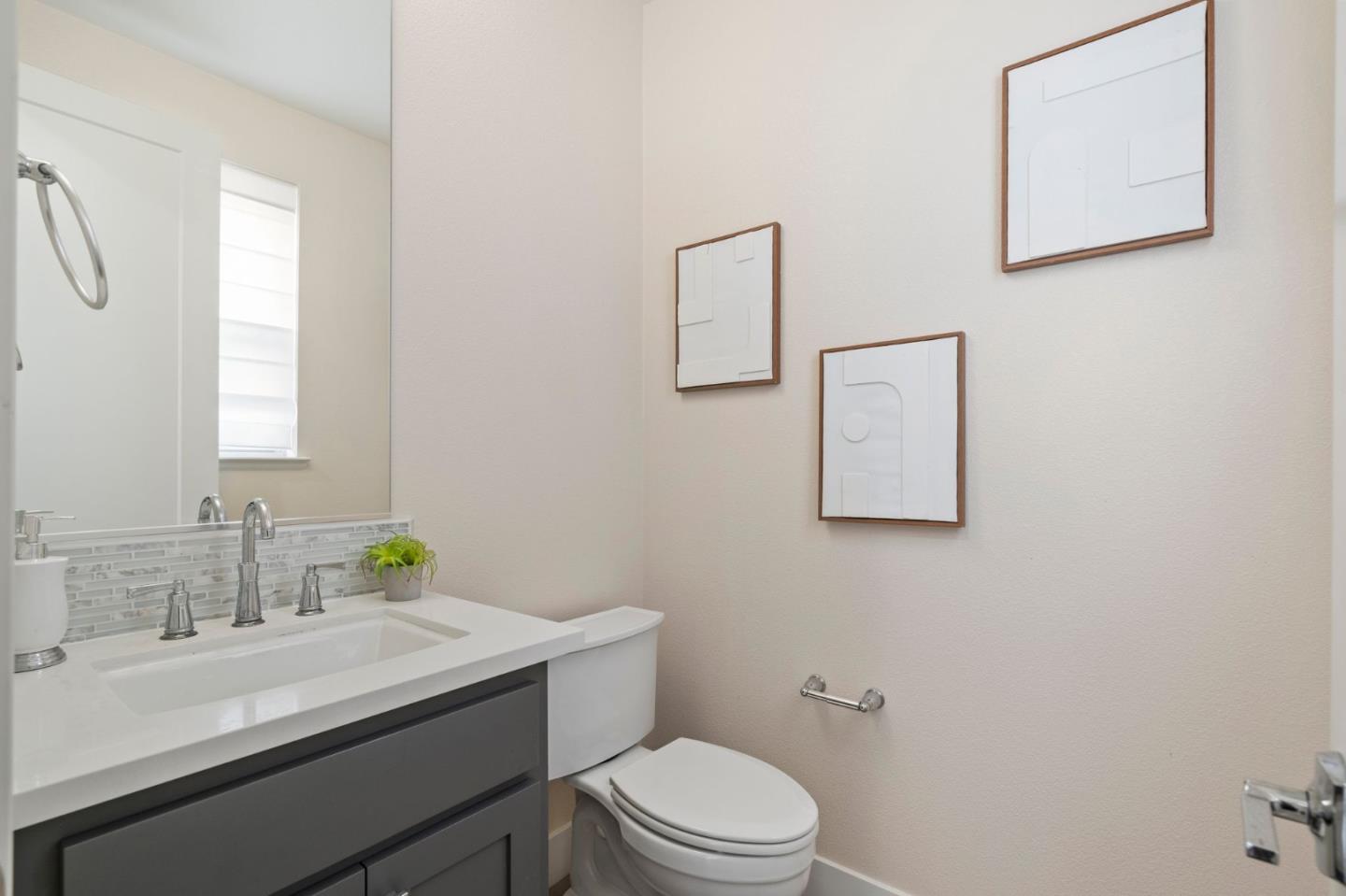 192 Melia Loop Mountain View, CA 94043 - Photo 35 of 40 a bathroom with a granite countertop sink a mirror and a toilet