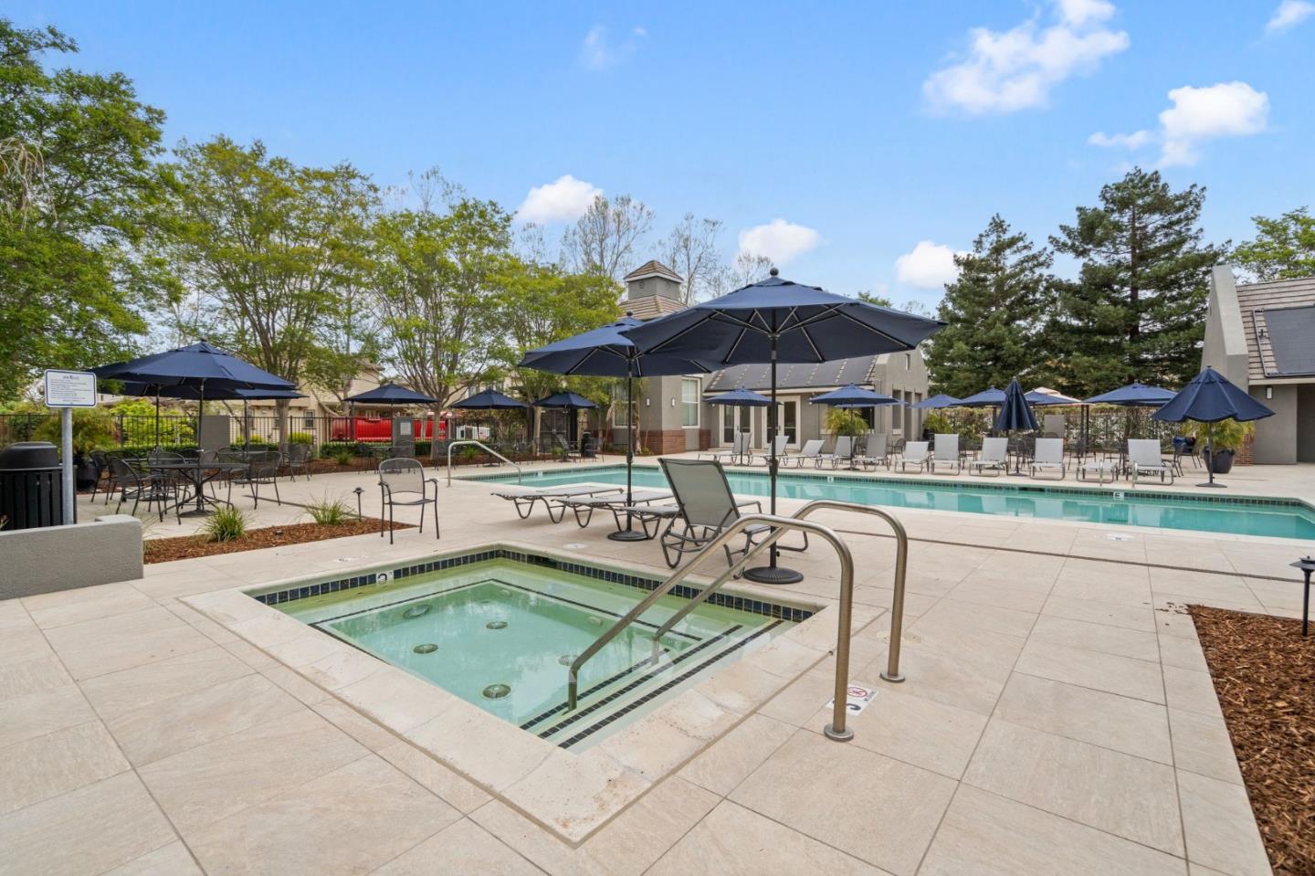 192 Melia Loop Mountain View, CA 94043 - Photo 40 of 40 a patio with a table and chairs under an umbrella