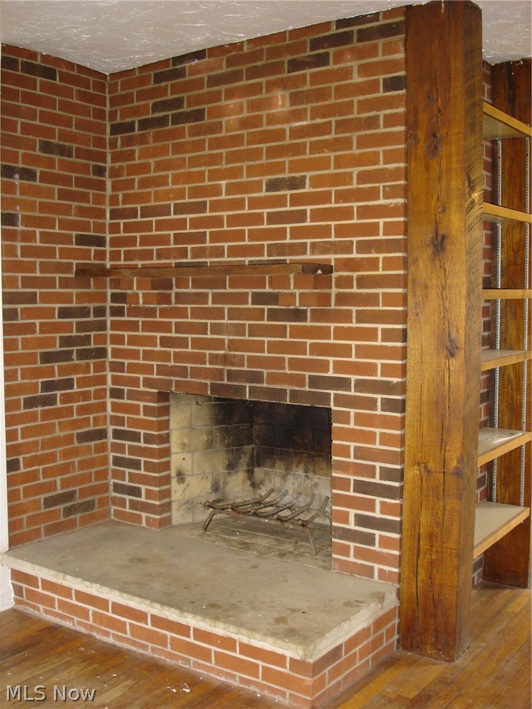 9733 Madison Road Montville, OH 44064 - Photo 12 of 31 Wood burning fireplace in living room.