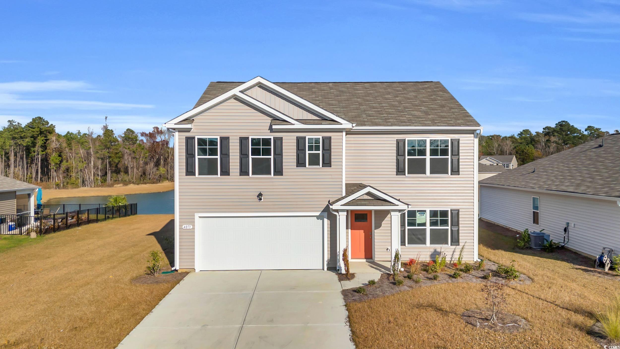 4071 Nelson Road Little River, SC 29566 - Photo 1 of 40 View of front facade with a front yard, central AC