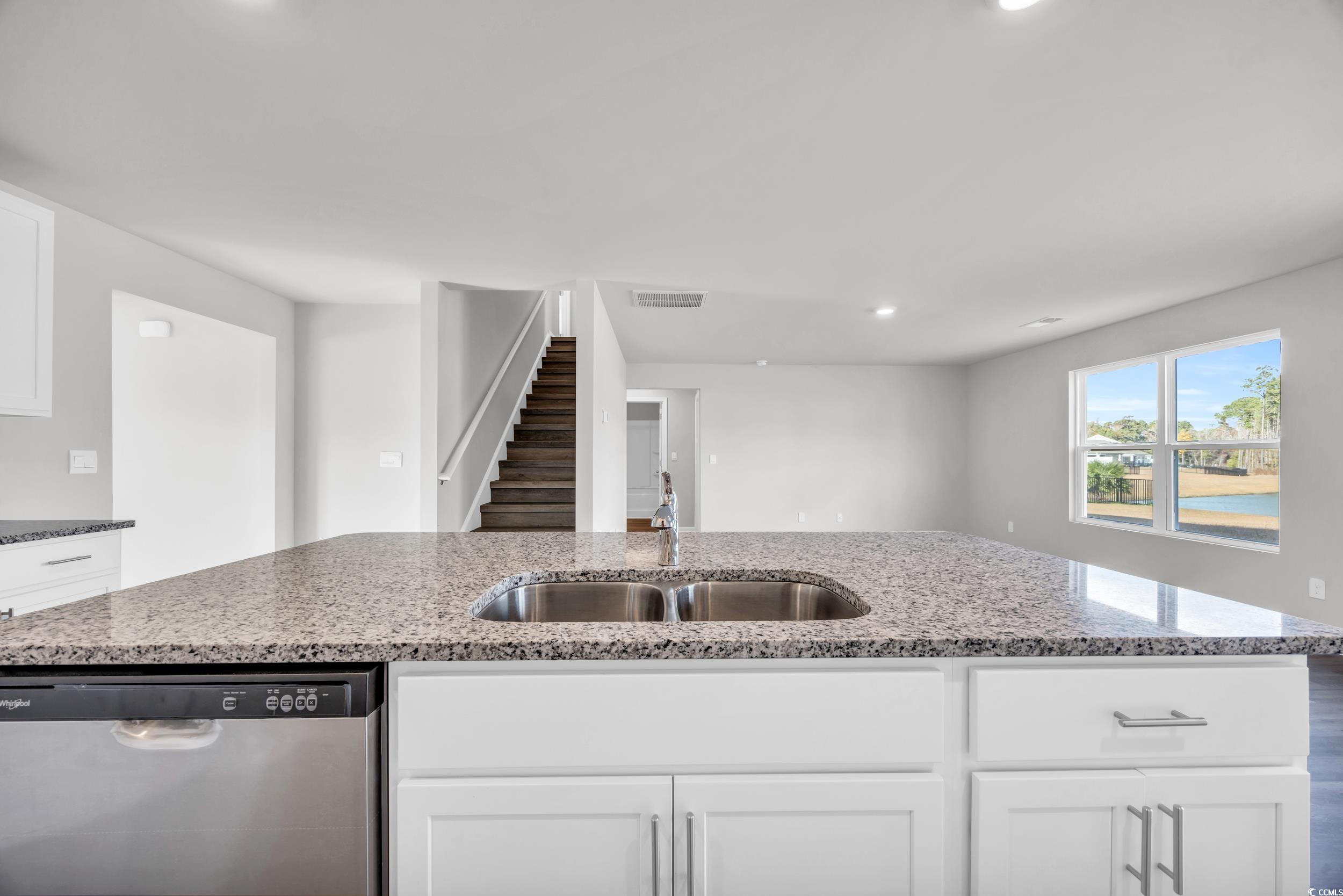 4071 Nelson Road Little River, SC 29566 - Photo 11 of 40 Kitchen featuring dishwasher, white cabinets, ligh
