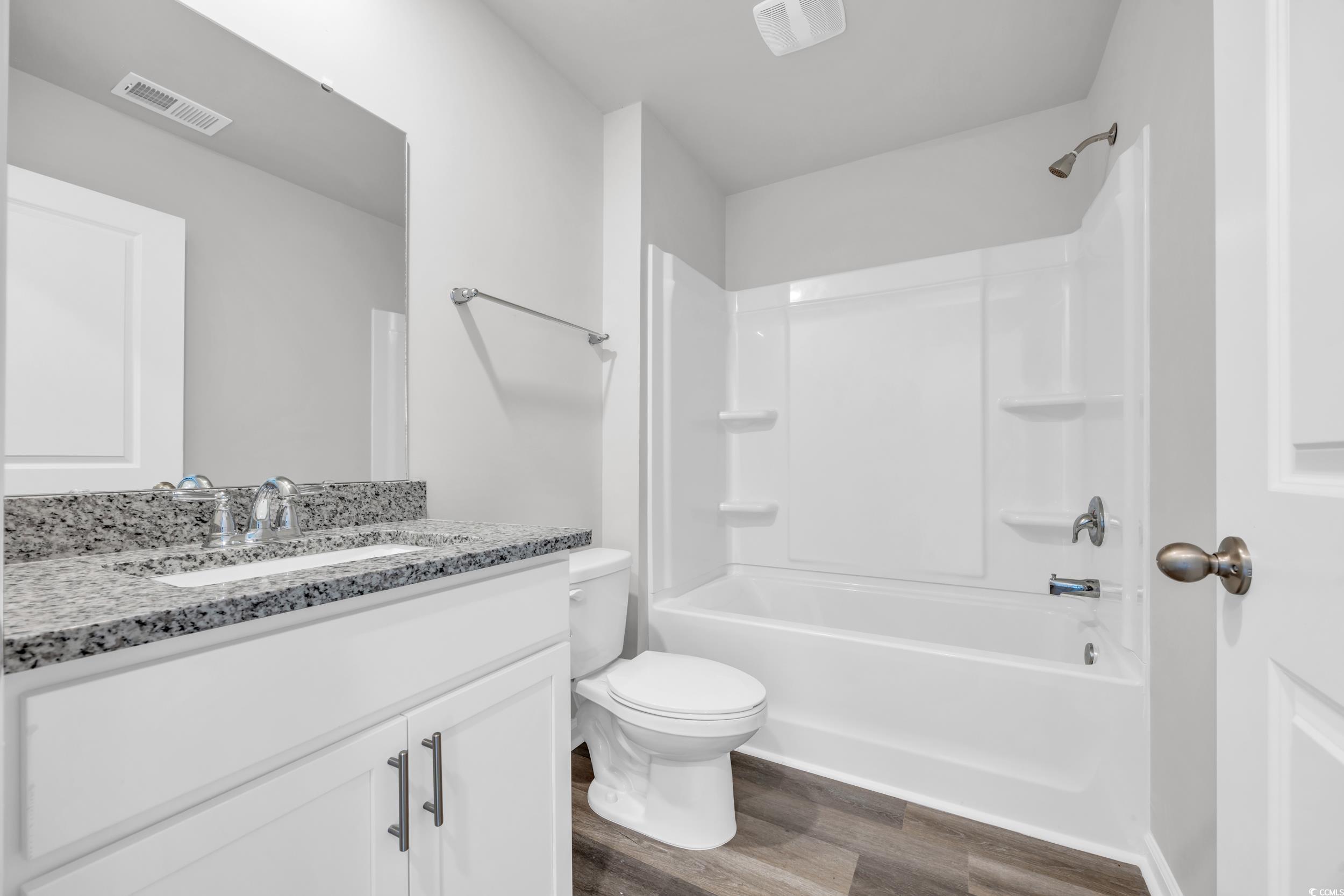 4071 Nelson Road Little River, SC 29566 - Photo 16 of 40 Full bathroom with wood-type flooring, vanity, sho