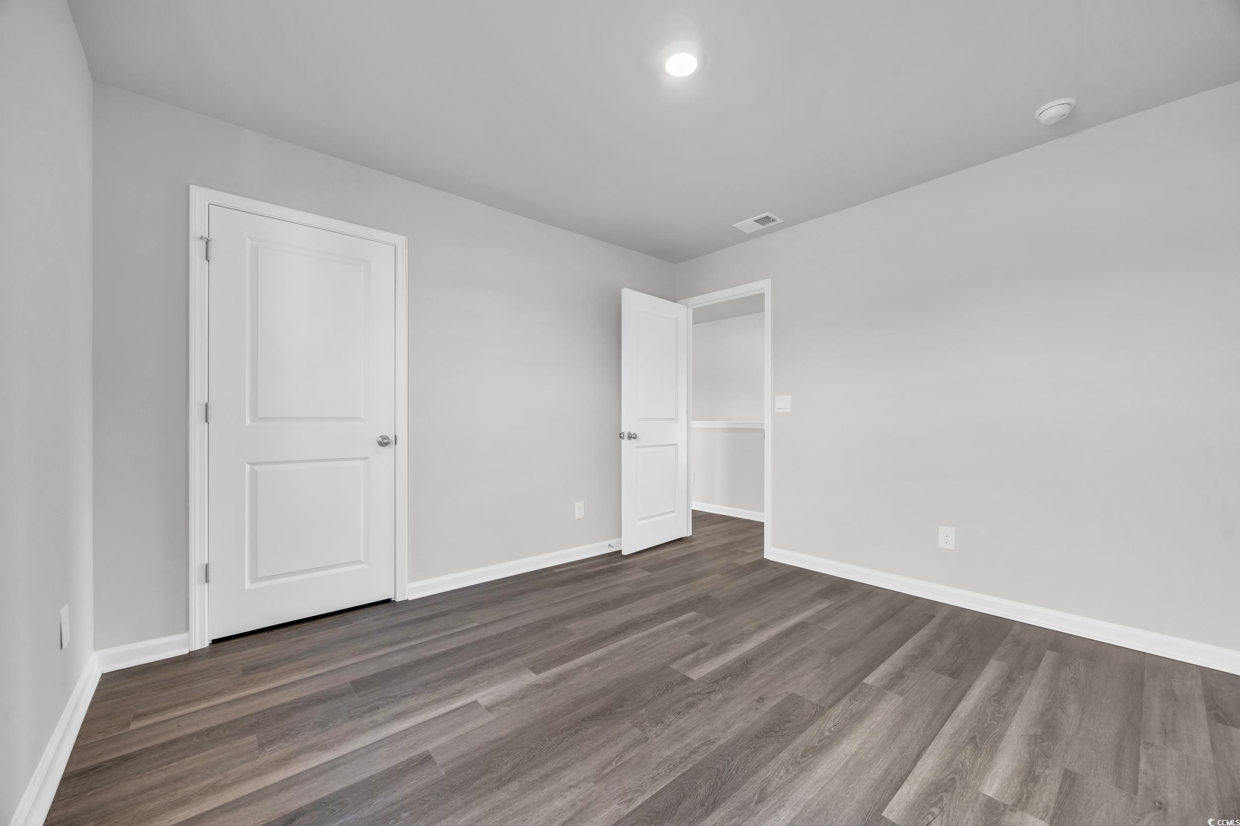 4071 Nelson Road Little River, SC 29566 - Photo 24 of 40 Unfurnished bedroom with dark wood-type flooring