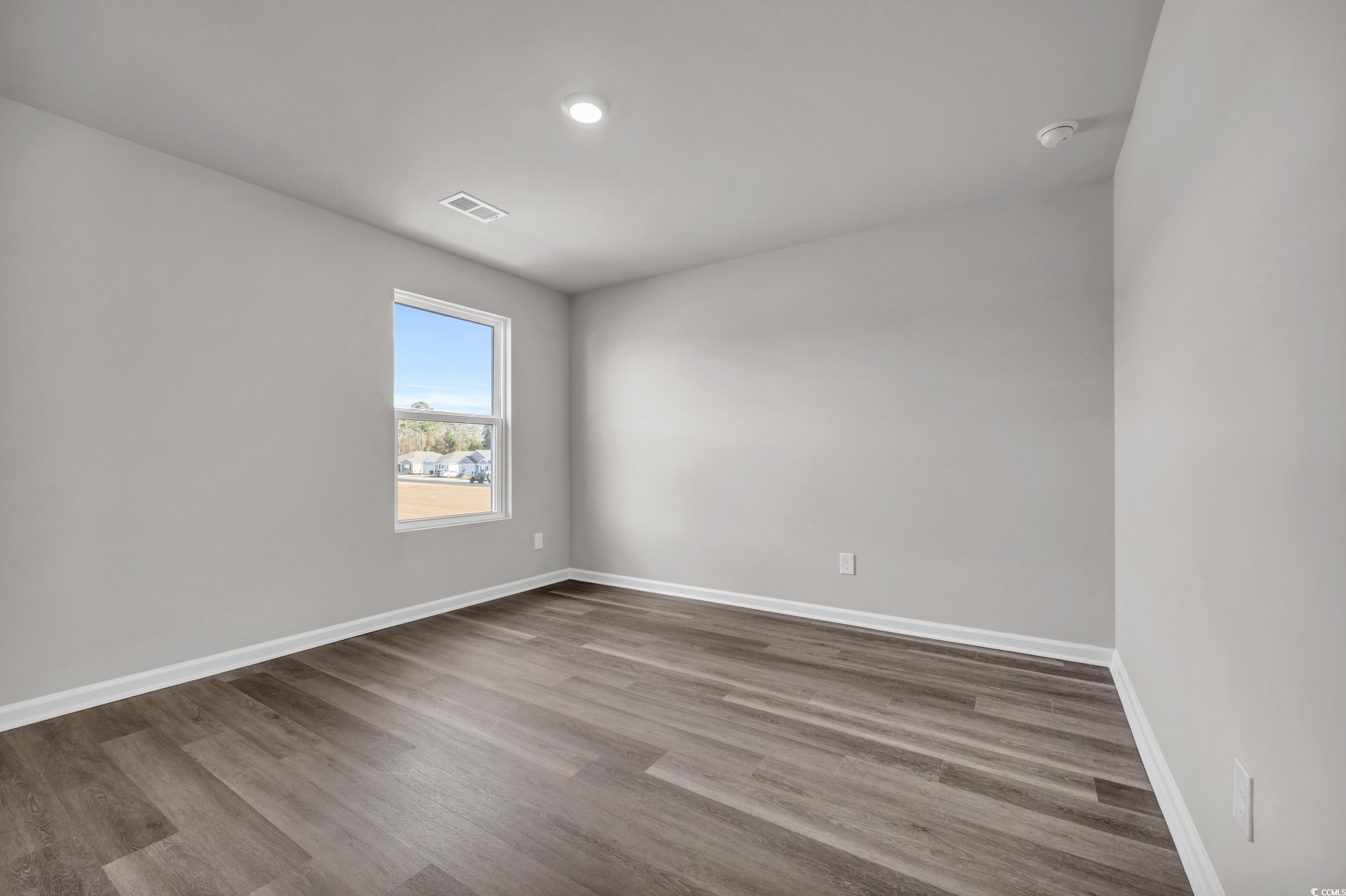 4071 Nelson Road Little River, SC 29566 - Photo 27 of 40 Spare room featuring wood-type flooring