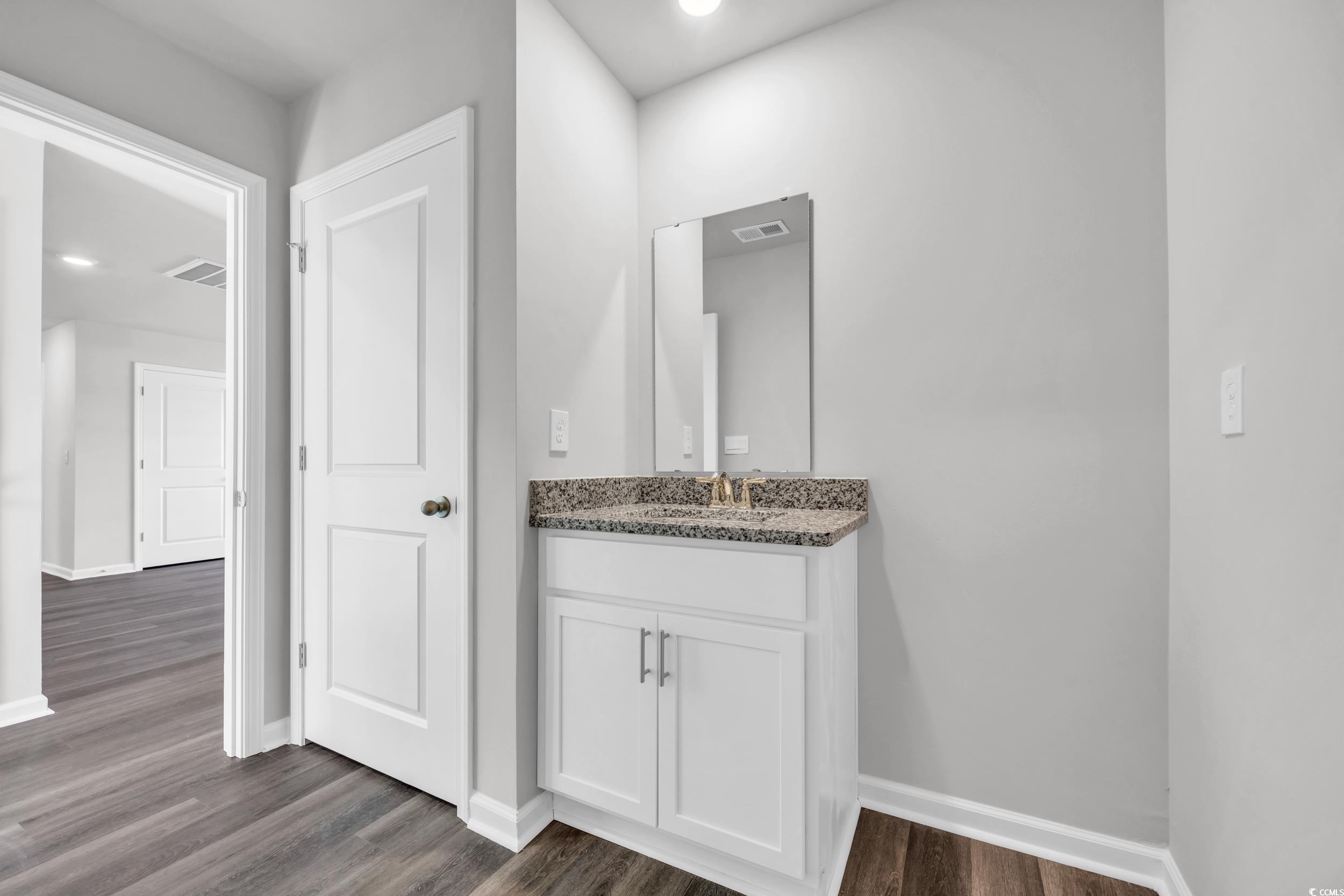 4071 Nelson Road Little River, SC 29566 - Photo 29 of 40 Bathroom with hardwood / wood-style floors and van