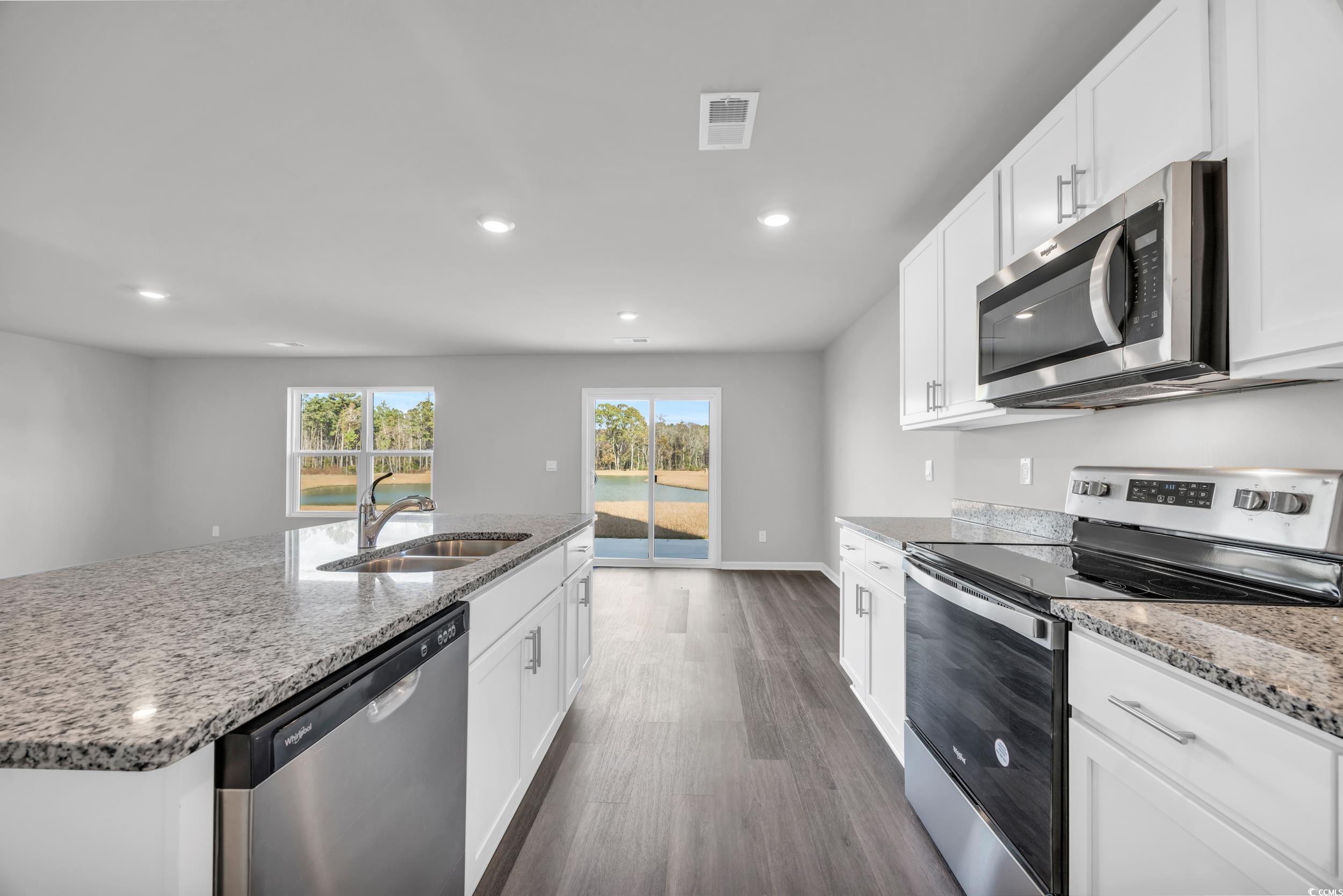 4071 Nelson Road Little River, SC 29566 - Photo 10 of 40 Kitchen with dark wood-type flooring, sink, an isl