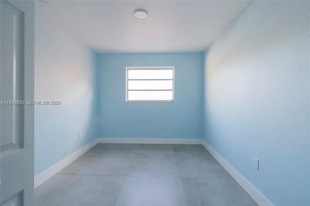 a backyard of a house with barbeque oven table and chairs