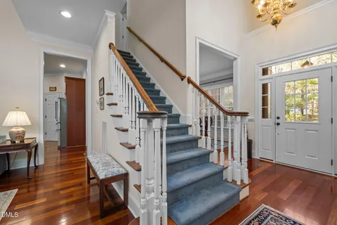 a view of entryway and hall with wooden floor