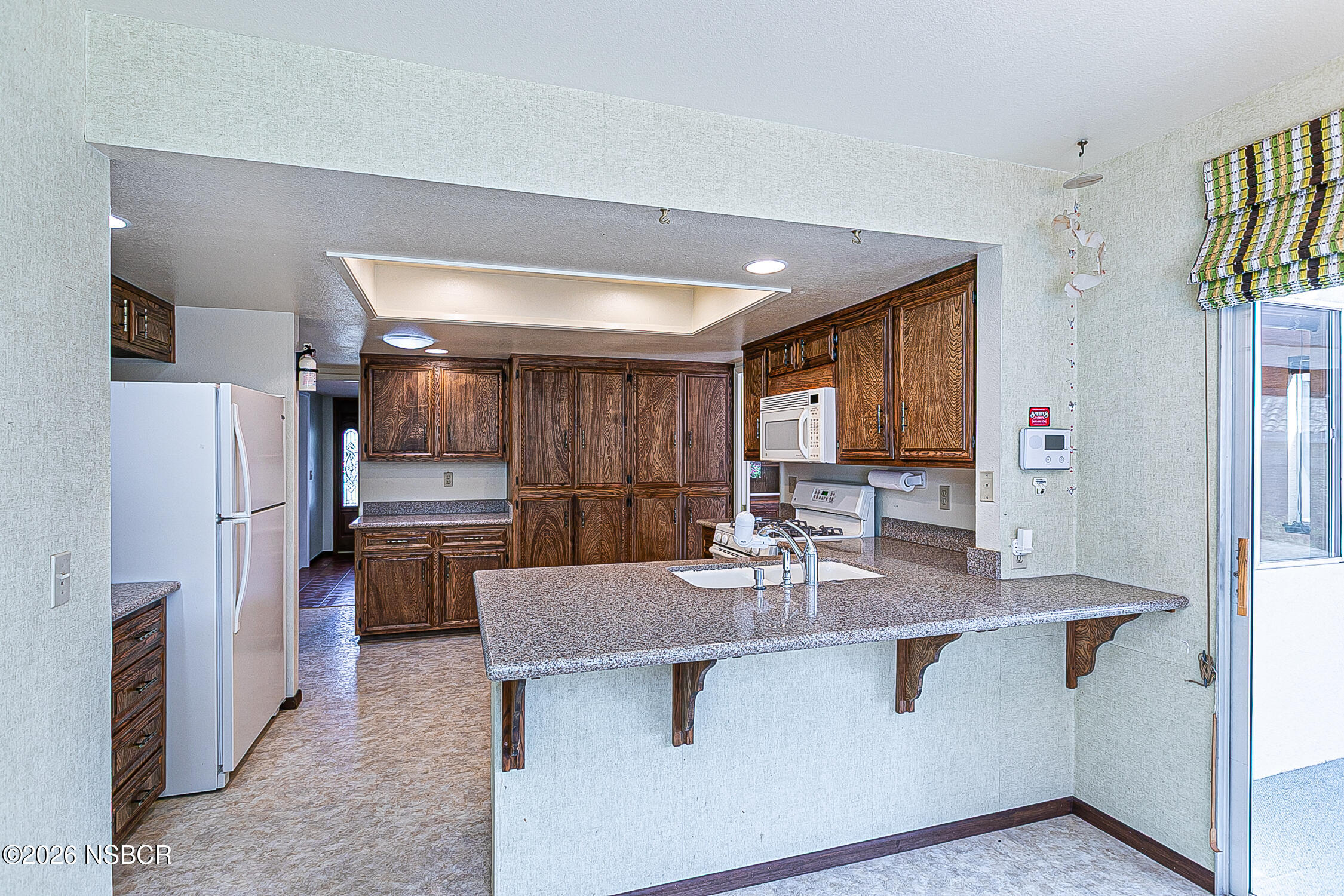 1260 Onstott Road Lompoc, CA 93436 - Photo 18 of 52 a kitchen with stainless steel appliances granite countertop a sink refrigerator and cabinets