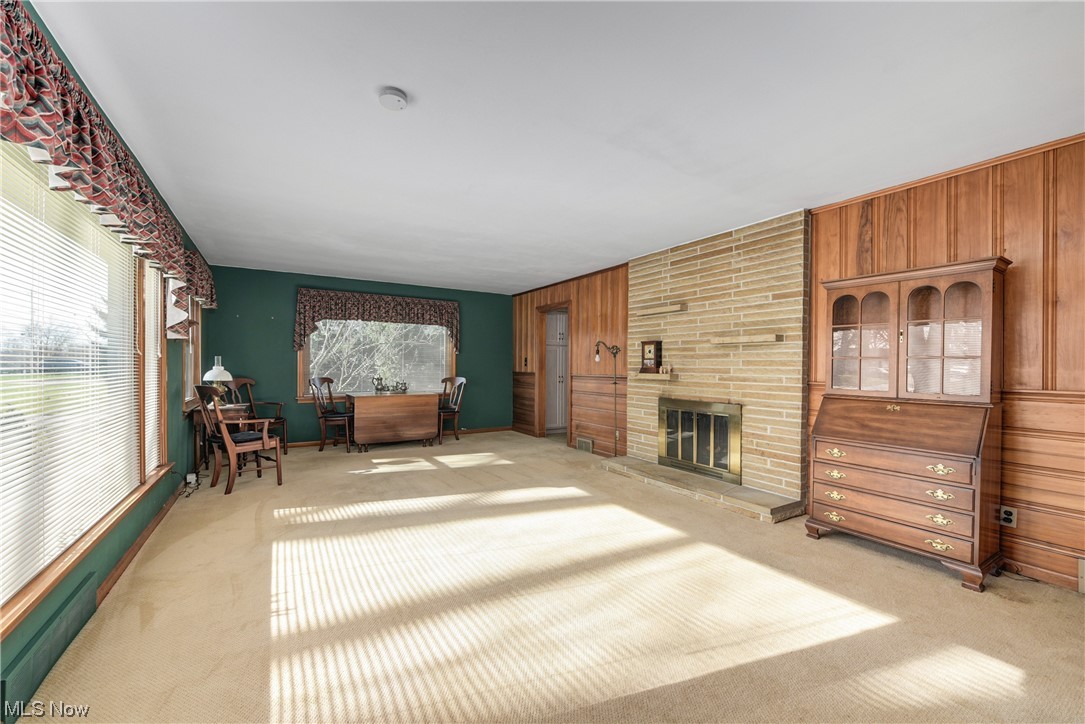 2640 West Sprague Road Cleveland, OH 44134 - Photo 12 of 35 Sitting room with a brick fireplace, wooden walls, and light carpet
