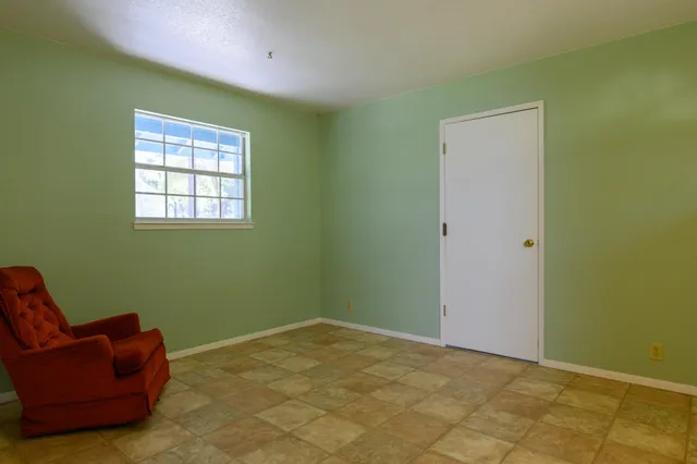 a view of room with window and lounge chair