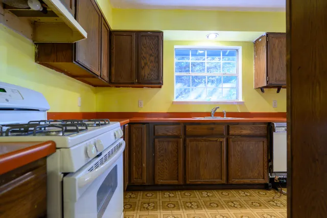 a kitchen with wooden cabinets and a stove top oven