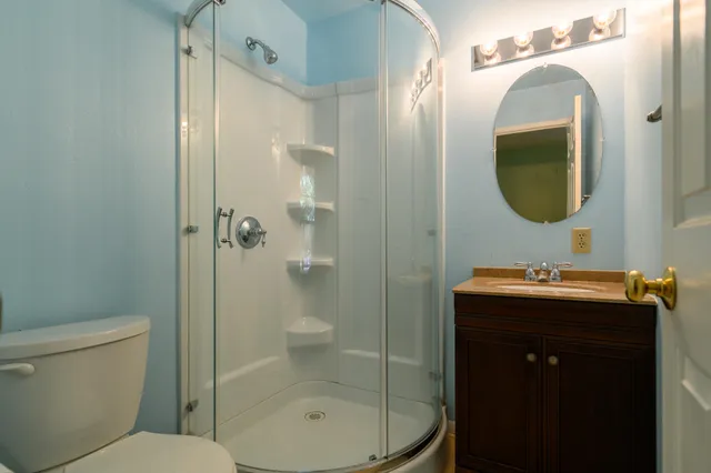 a bathroom with a toilet a sink and shower