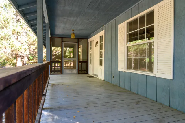 a view of a porch with wooden floor and stairs