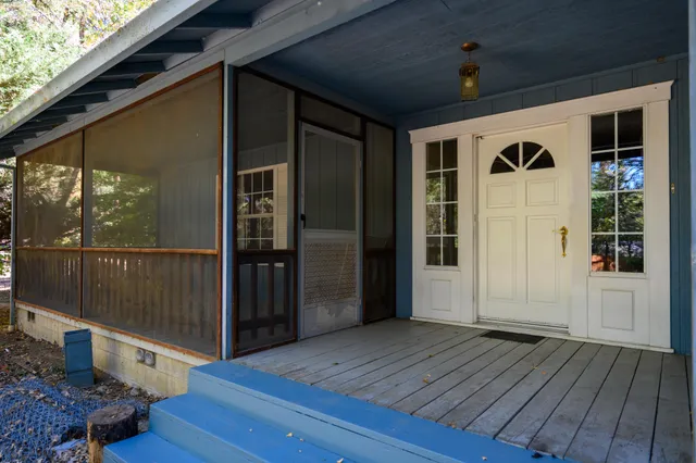 a view of front door deck and living room