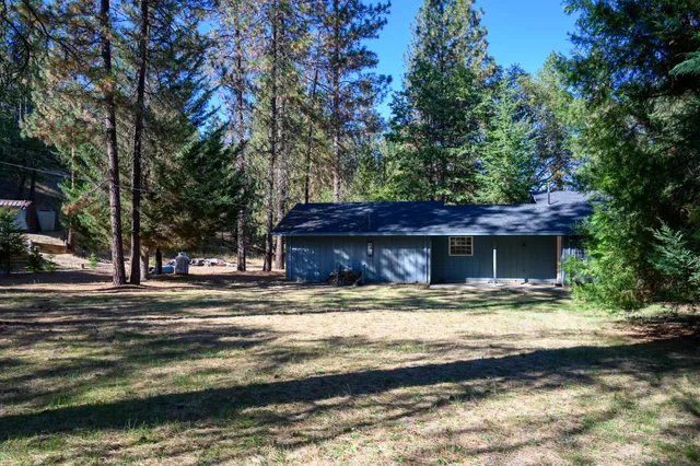 a view of a yard with a house in the background