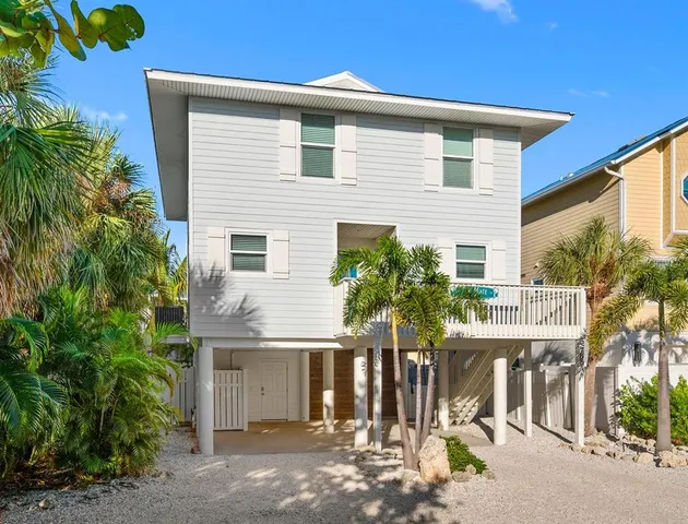 a front view of house with trees