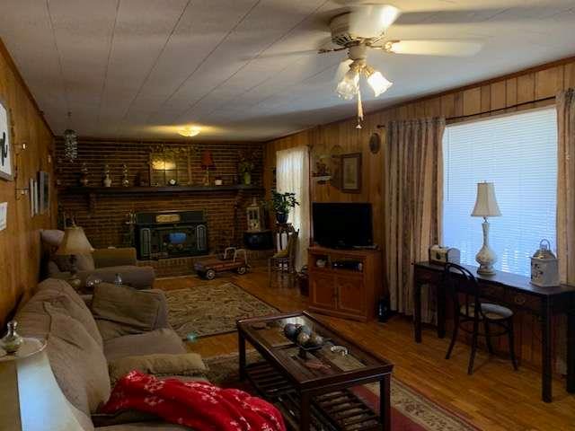 6815 Duncan Road Lula, GA 30554 - Photo 11 of 31 a living room with furniture a flat screen tv and a fireplace