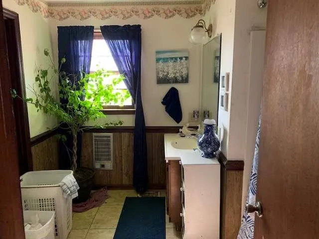 a bathroom with a sink toilet and window