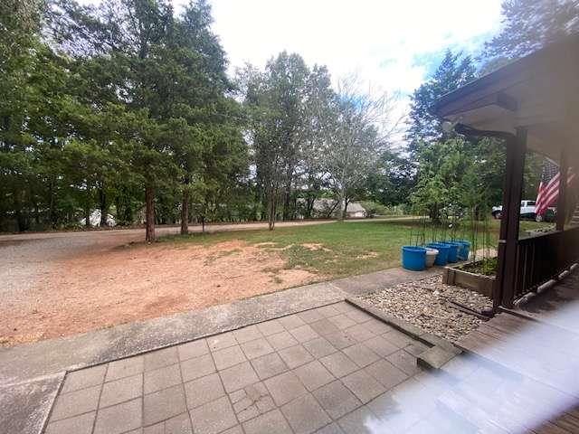 6815 Duncan Road Lula, GA 30554 - Photo 24 of 31 a view of a backyard with water fountain and large trees
