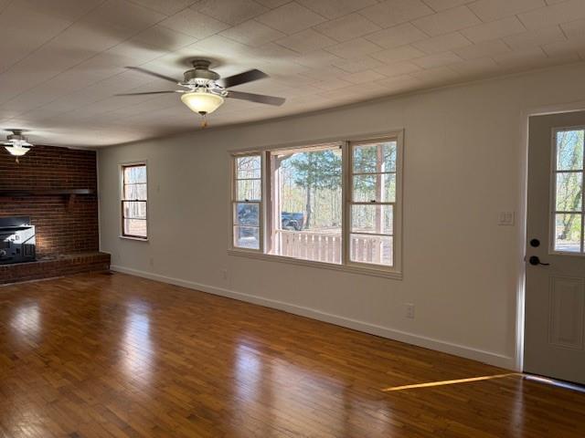 6815 Duncan Road Lula, GA 30554 - Photo 6 of 44 a view of an empty room with wooden floor and a window