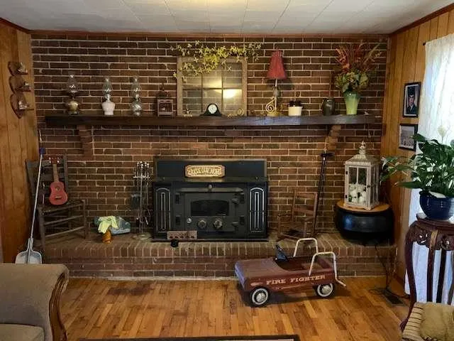 a living room with furniture a fireplace and potted plants